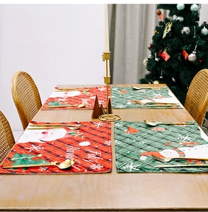 Christmas placemats with Santa Claus and snowman motifs on a festive wooden table set