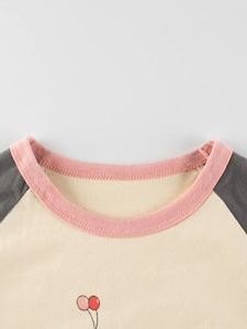 Kids long sleeve cotton T-shirt featuring pink ribbed neckline and balloon print details