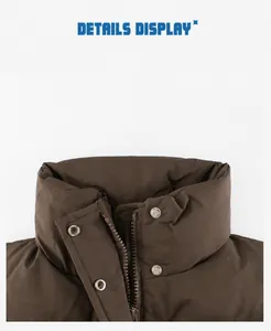Detail view of children's windproof brown puffer vest featuring high stand collar and metal button
