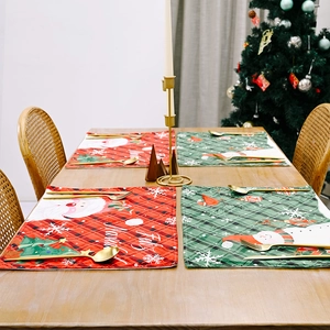Christmas table mat set with Santa and snowman patterns on festive wooden table decor