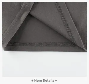 Macro detail of the double-needle stitching on the hem of this grey boys' cotton T-shirt