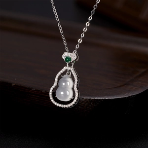 Close-up of a double gourd pendant with white chalcedony and shimmering micro-set diamonds