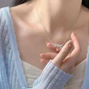 Elegant silver wheat ear necklace with clear zircon stones on a model's collarbone
