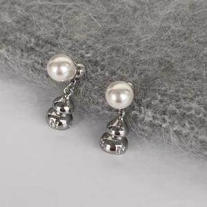 Elegant silver gourd pearl earrings with vintage floral engraving on knit background
