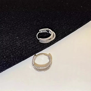 Silver multi-layered C-shaped hoop earrings with sparkling pavé crystals and textured finish