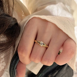 Vintage gold oval moissanite ring with starburst engraving worn on hand for lifestyle look