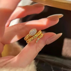 Detailed close-up of a gold-plated snake ring featuring micro-paved cubic zirconia stones