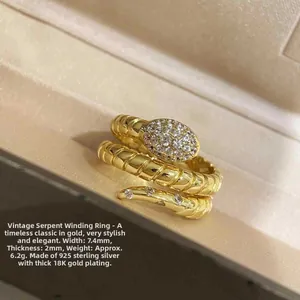 Detailed macro shot of vintage silver snake ring with 18K gold plating and cubic zirconia