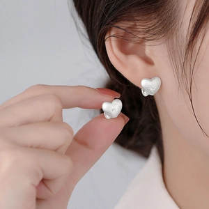 Minimalist matte silver heart stud earrings with star engraving and brushed metal finish