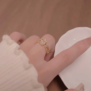 Elegant gold-plated open ring with translucent stone and hollow pattern on model hand