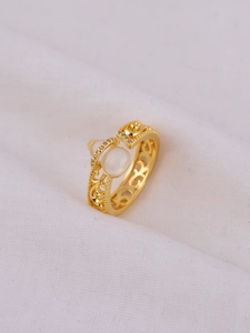 Macro shot of gold-plated gourd ring featuring white jade and intricate hollow patterns