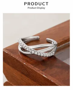 Macro shot of silver triple-layered cross ring with cubic zirconia micro-inlay detail