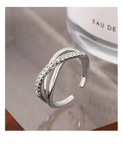 Macro shot of silver X-shaped layered ring featuring micro-pave cubic zirconia crystals