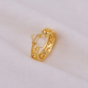 Luxurious gold hollow ring with pear-shaped white gemstone and elegant rose flower