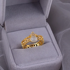 Elegant gold hollow ring with white jade gourd and fine zircons in a 45-degree view