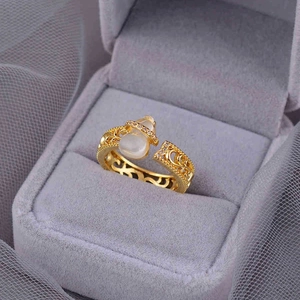 Luxury gold hollow gourd ring with white gemstone and delicate micro-pave detailing