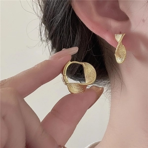 Elegant gold twisted hoop earrings with textured woven finish for women fashion