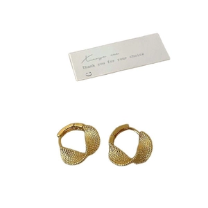 Golden textured geometric hoop earrings with matte finish on a minimalist white background