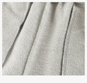 Close-up of light grey cotton knit fabric texture and high-quality overlock stitching