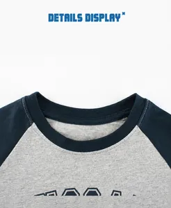 Close-up of the ribbed crew neck and raglan sleeve stitching on a kids cotton t-shirt