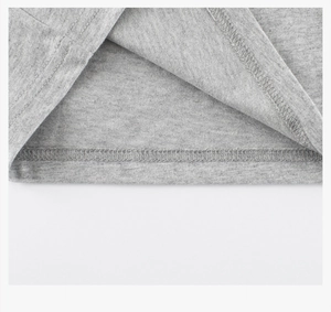 Close-up of heather grey cotton fabric showing precise double-needle coverstitch hem detail