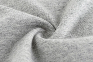 Close-up of heather grey knitted fabric texture showing soft cotton weave on kids t-shirt