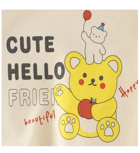 Detailed close-up of a cute cartoon bear print on off-white knit sweater for kids