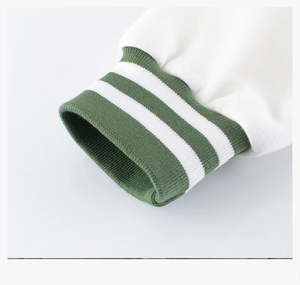 Detail of green ribbed cuffs with white stripes on a white baseball jacket sleeve