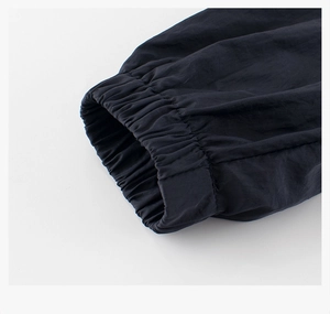Detail view of elasticated ribbed cuffs on children windbreaker with durable stitching