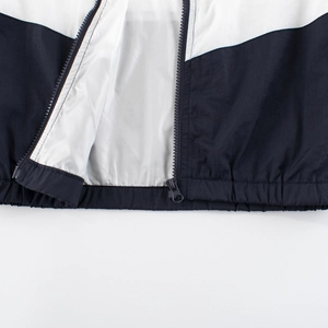 Close-up of black and white contrast windbreaker with zipper and white inner lining detail