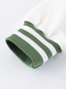 Close-up of green ribbed cuffs with white double stripes on a kids' fleece baseball jacket