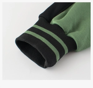Detail of green and black ribbed cuff on a fleece baseball jacket for children