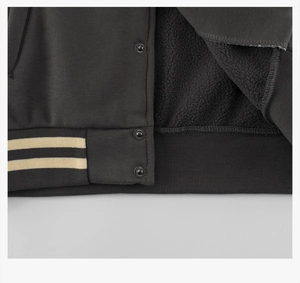 Detail of warm black fleece lining and striped ribbed hem with metal snap buttons