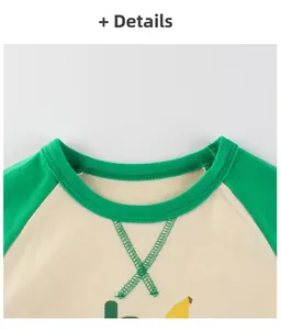 Detail of girls' long sleeve cotton t-shirt collar with green contrast raglan stitching