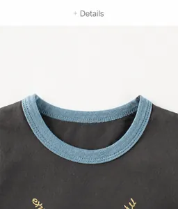 Detail of round neckline with blue ribbed trim on dark gray knitted cotton t-shirt