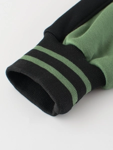 Close-up of kids baseball jacket with thick cotton fabric and striped ribbed cuffs