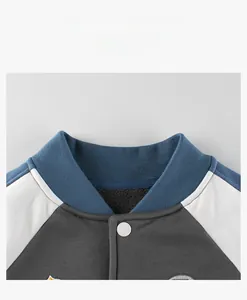 Close-up of ribbed baseball collar and fleece lining on color-block kids jacket