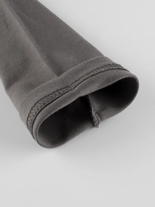 Detail of double-needle stitching on long-sleeve knit shirt cuff for children