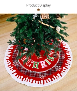 Detail of red Christmas tree skirt with Merry Christmas text and snowflake patterns