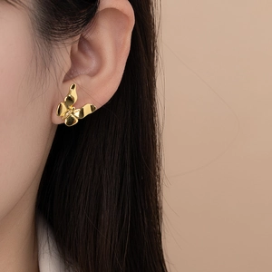 Elegant gold butterfly stud earrings with small crystals and 3D textured design