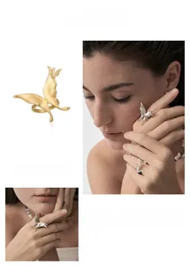 Detailed view of 3D butterfly wing ring in gold and silver matte finishes