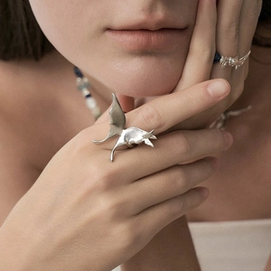 Exquisite silver bat-wing ring with detailed 3D design shown on model's finger