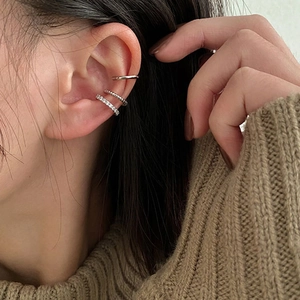 Three-piece silver ear cuff set featuring smooth, twisted, and zircon-encrusted designs