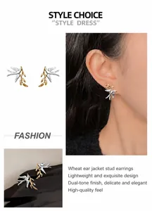 Macro detail of bird and branch stud earrings in silver and gold two-tone finish