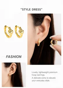 Macro detail of gold heart earrings with twisted texture and chic vintage design
