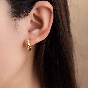 Minimalist gold heart hoop earrings for women shown as worn on a real ear model