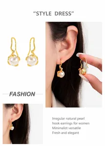 Detail showing irregular gold metal earrings with natural pearls worn by a model