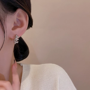 French style silver spiral knot hoop earrings with a minimalist twisted spring design