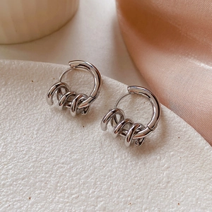 Detail view of French style knotted hoop earrings with polished silver spiral rings