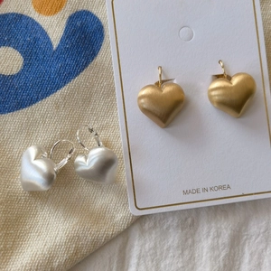 Minimalist brushed metal heart hoop earrings in gold and silver finishes